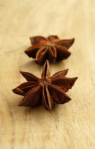 Two brown star anise on the board — Stock Photo, Image