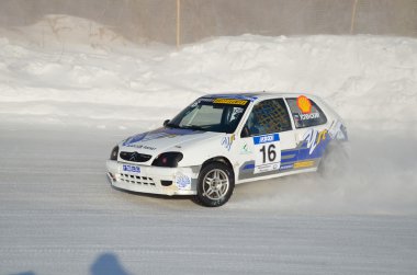 Sports car turns into a skid on the icy track clipart