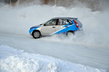 Sports car turns into a skid on the icy track clipart