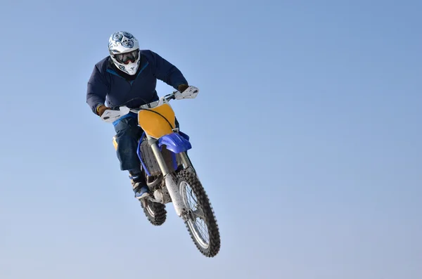 Motocross, flying on bike on blue background — Stock Photo, Image