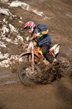 Motocross racer is turning in gauge line with a spray of dirt clipart