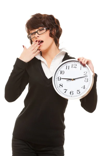 Studio portrait of tired woman with clock — Stock Photo, Image