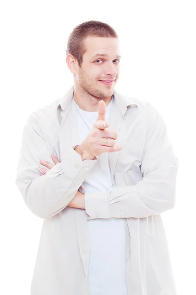 Studio shot of young smiley man pointing — Stock Photo, Image