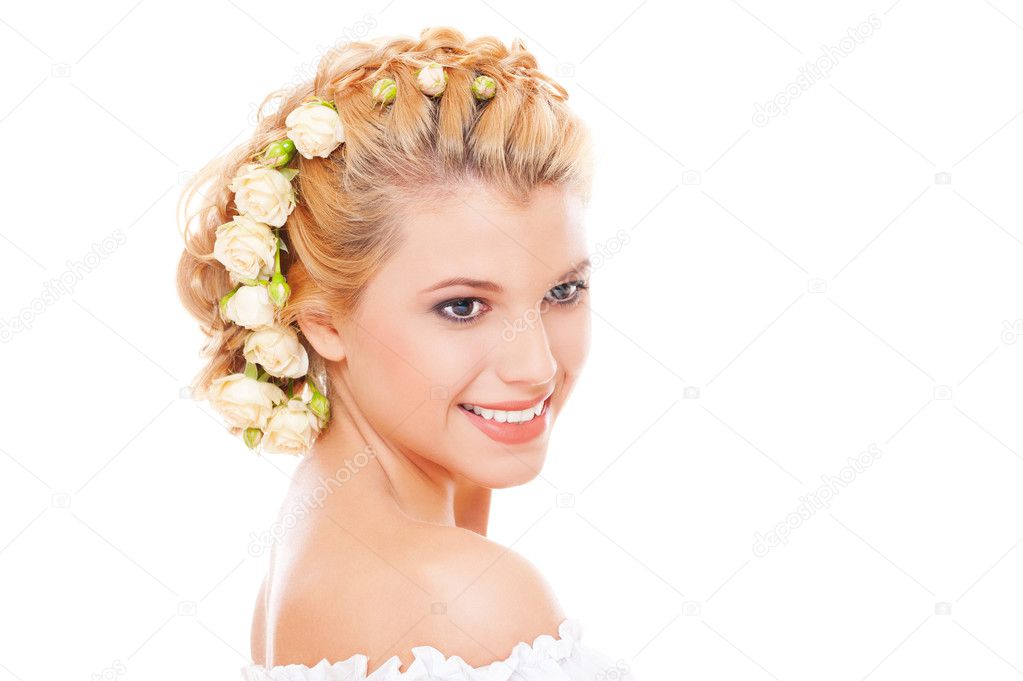 Studio shot of smiley woman with roses in her hair