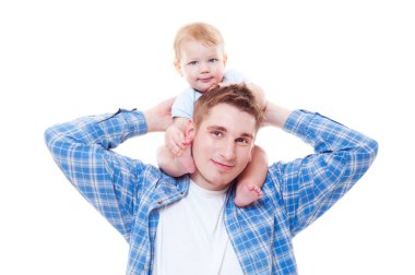 Studio shot of little boy sitting on shoulders of his father clipart