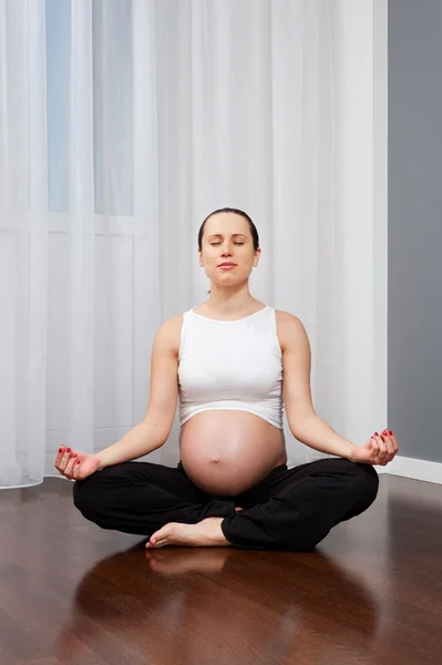 Těhotná žena se zavřenýma očima, cvičení jógy — Stock fotografie