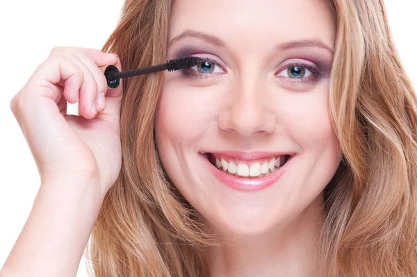 Closeup portrait of young woman applying make up — Stock Photo, Image