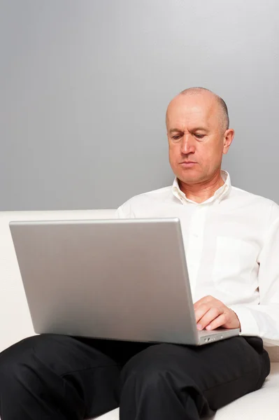 Man in wit overhemd met laptop — Stockfoto