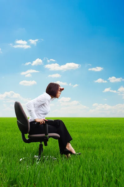 Serious businesswoman looking forward on the meadow — Stock Photo, Image