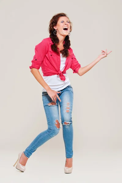 Studio shot of happy woman playing air guitar — Stock Photo, Image