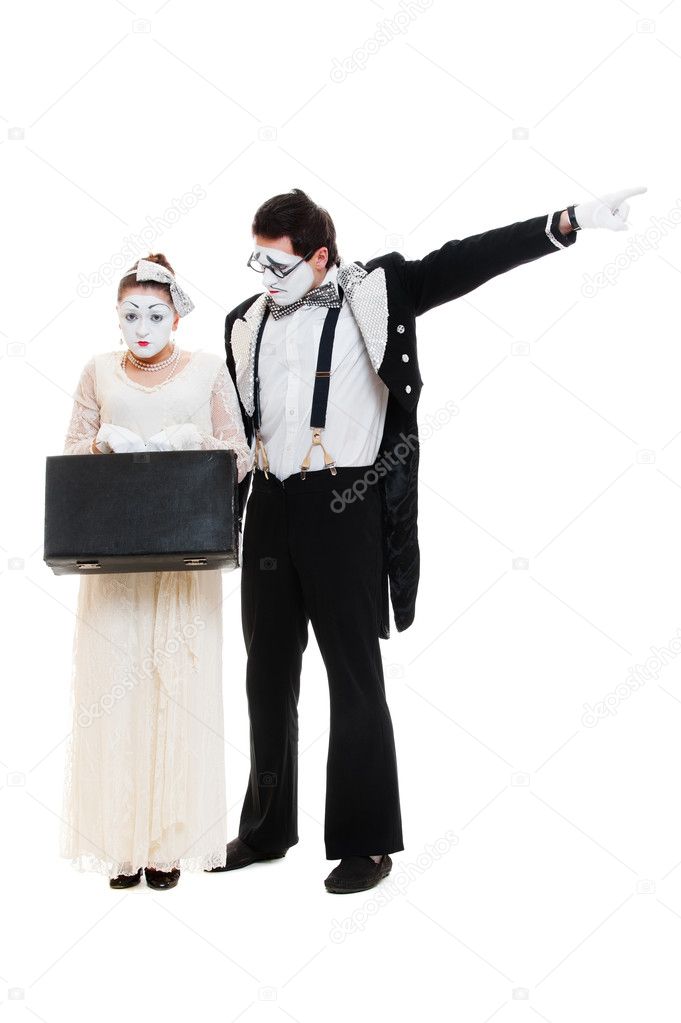 Studio shot of mimes with suitcase