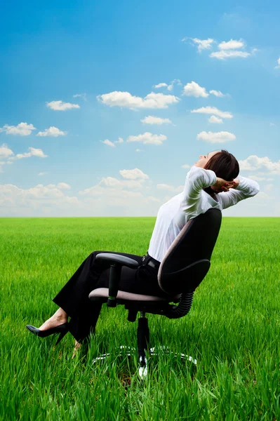 Woman relaxing in armchair at the meadow — Stock Photo, Image