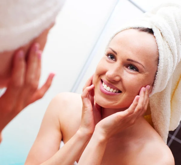 Smiley woman looking at mirror after shower — Stock Photo, Image