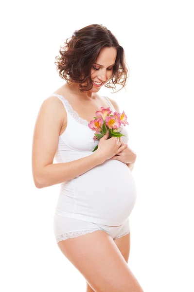 Mujer embarazada en lencería sosteniendo flores —  Fotos de Stock