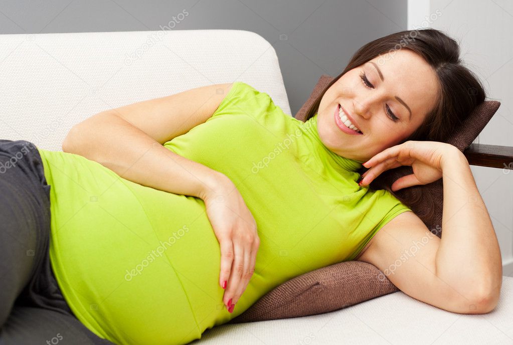 Pregnant woman resting on sofa