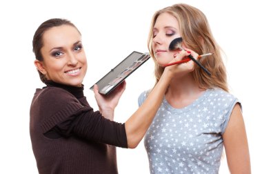 Esthetician applying eyeshadow clipart