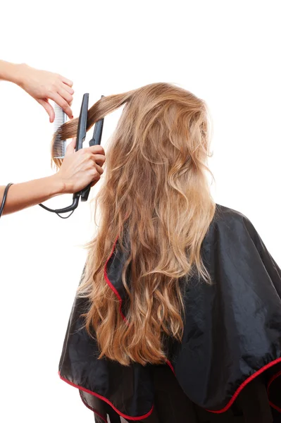 Hairdresser straightening hair — Stock Photo, Image