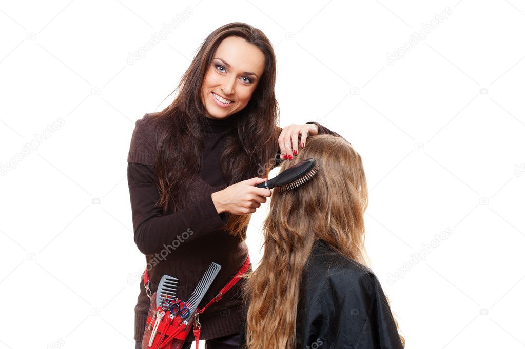 Smiley hairdresser doing hairstyle