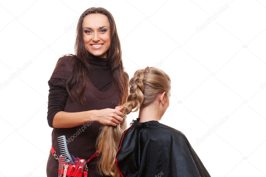 Studio shot of smiley hairdresser doing a plait