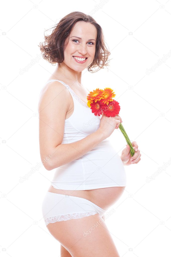 Studio picture of smiley pregnant woman with flower