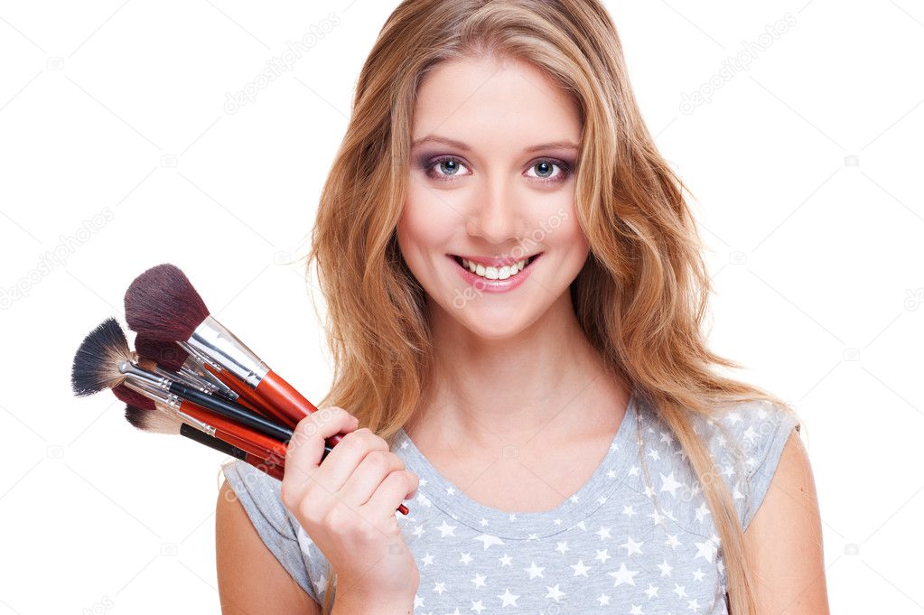 Smiley woman with make-up brushes