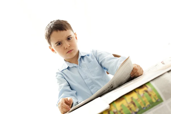 Upsed little boy with newspaper — Stock Photo, Image