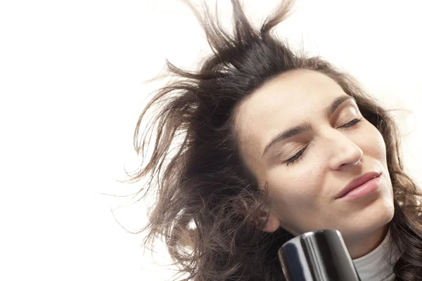 Young woman with hair dryer — Stock Photo, Image