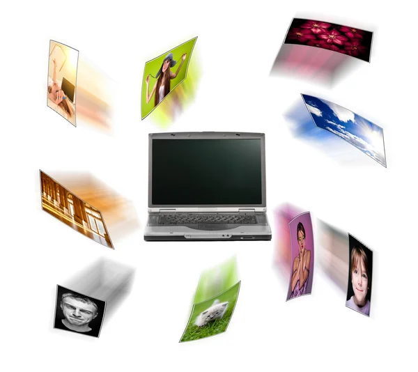 Un ordenador portátil y fotos digitales volando . —  Fotos de Stock