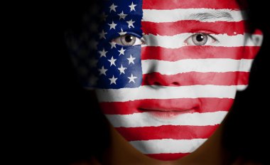 Child face painted with the flag of USA. clipart