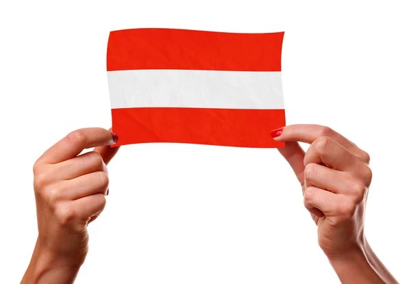 The Austrian flag in the woman hands — Stock Photo, Image