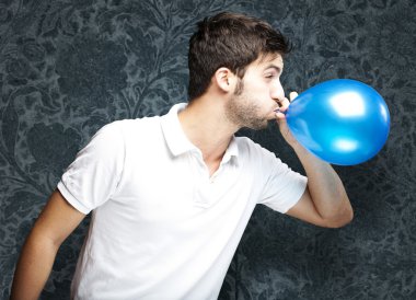 Man blowing balloon clipart