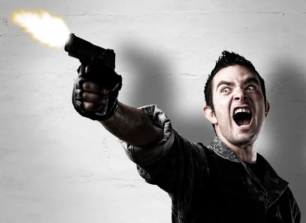 Man shooting a gun — Stock Photo, Image