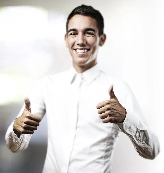 Young man with thumbs up — Stock Photo, Image