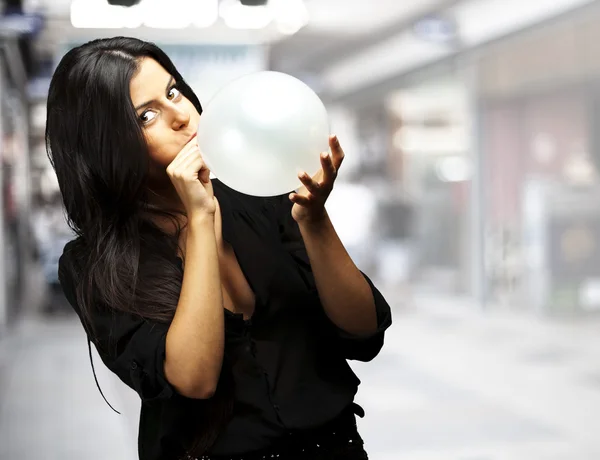 Kvinna blåser ballong — Stockfoto