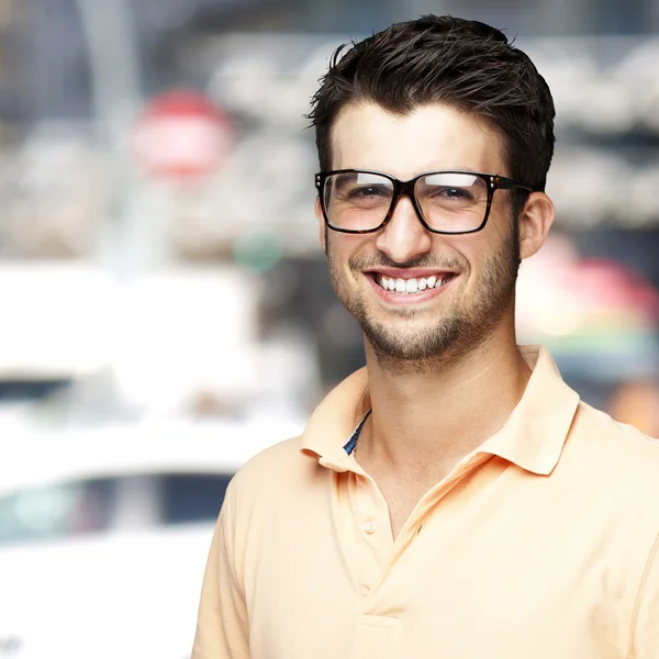 Portrait of a comely young man smiling against an abstract background — Stock Photo, Image