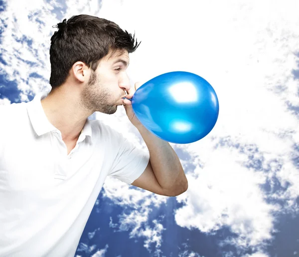 Man blowing balloon — Stock Photo, Image