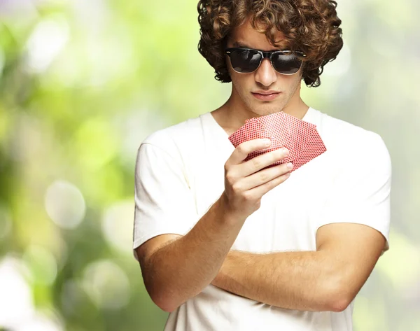 Portretul unui tânăr purtând ochelari de soare și jucând din nou poker — Fotografie, imagine de stoc