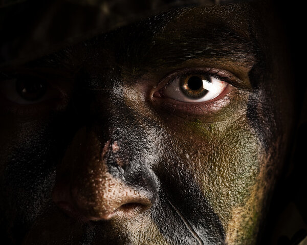 Camouflage painted face Stock Photo