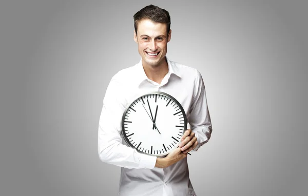 Man holding clock Stock Picture