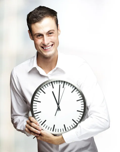 Man holding clock Stock Picture