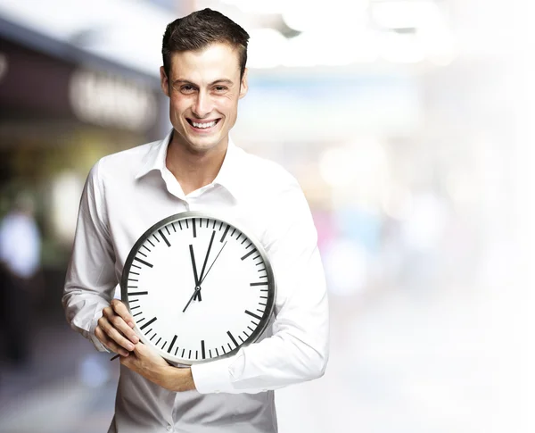 Man holding clock Stock Photo