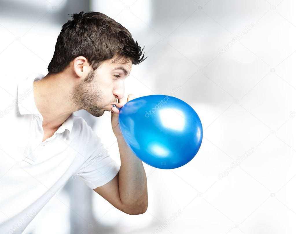 Man blowing balloon Stock Photo by © 10178393