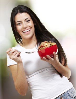 Woman holding a bowl with cereals clipart