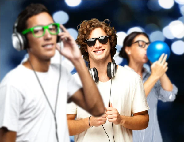 Portrait of young having a party against a blue lights — Stock Photo, Image