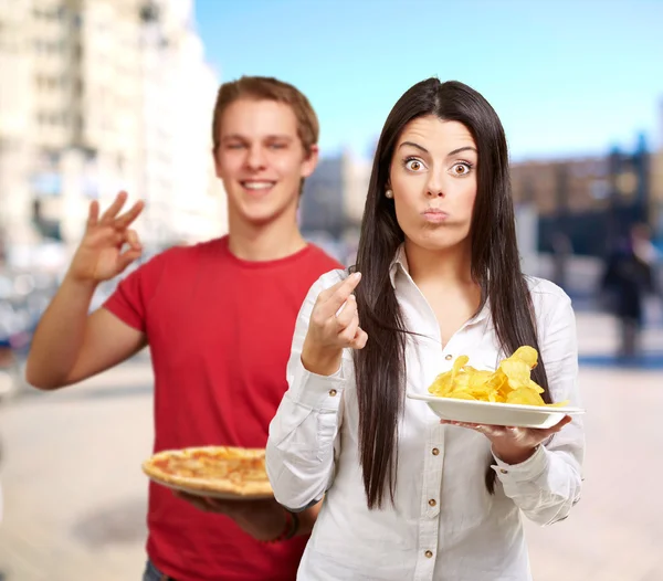 Portrait de jeunes amis tenant pizza et croustilles chez ster — Photo
