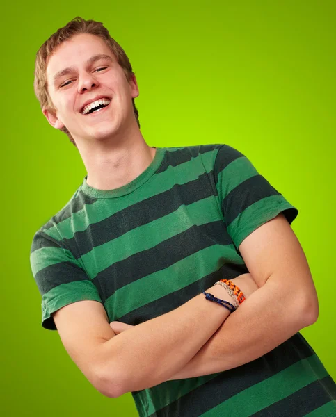 Portrait of young man smiling over green background — Stock Photo, Image