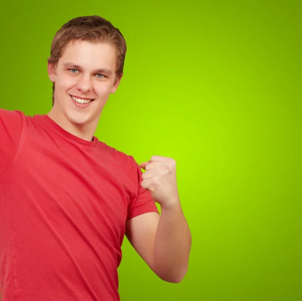 Yeşil arka plan üzerinde zafer kutluyor youn adam — Stok fotoğraf