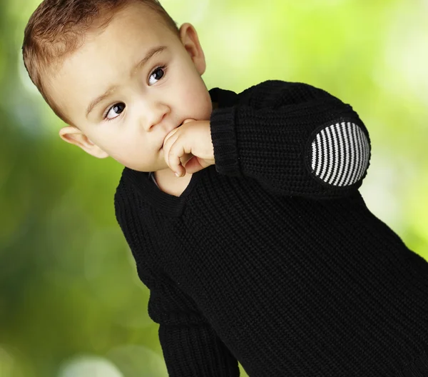 Portrait of adorable kid thinking against a nature background — Stock Photo, Image