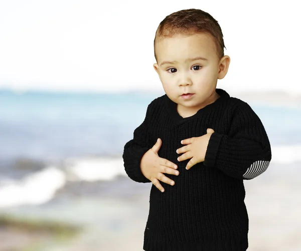 stock image Portrait of adorable kid touching his stomach near the sea shore