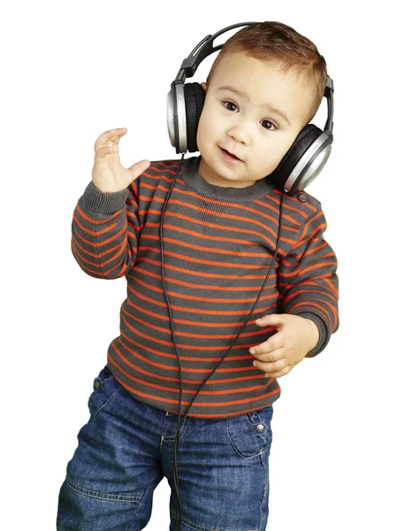 Portrait of adorable kid with headphones listening to music agai — Stock Photo, Image
